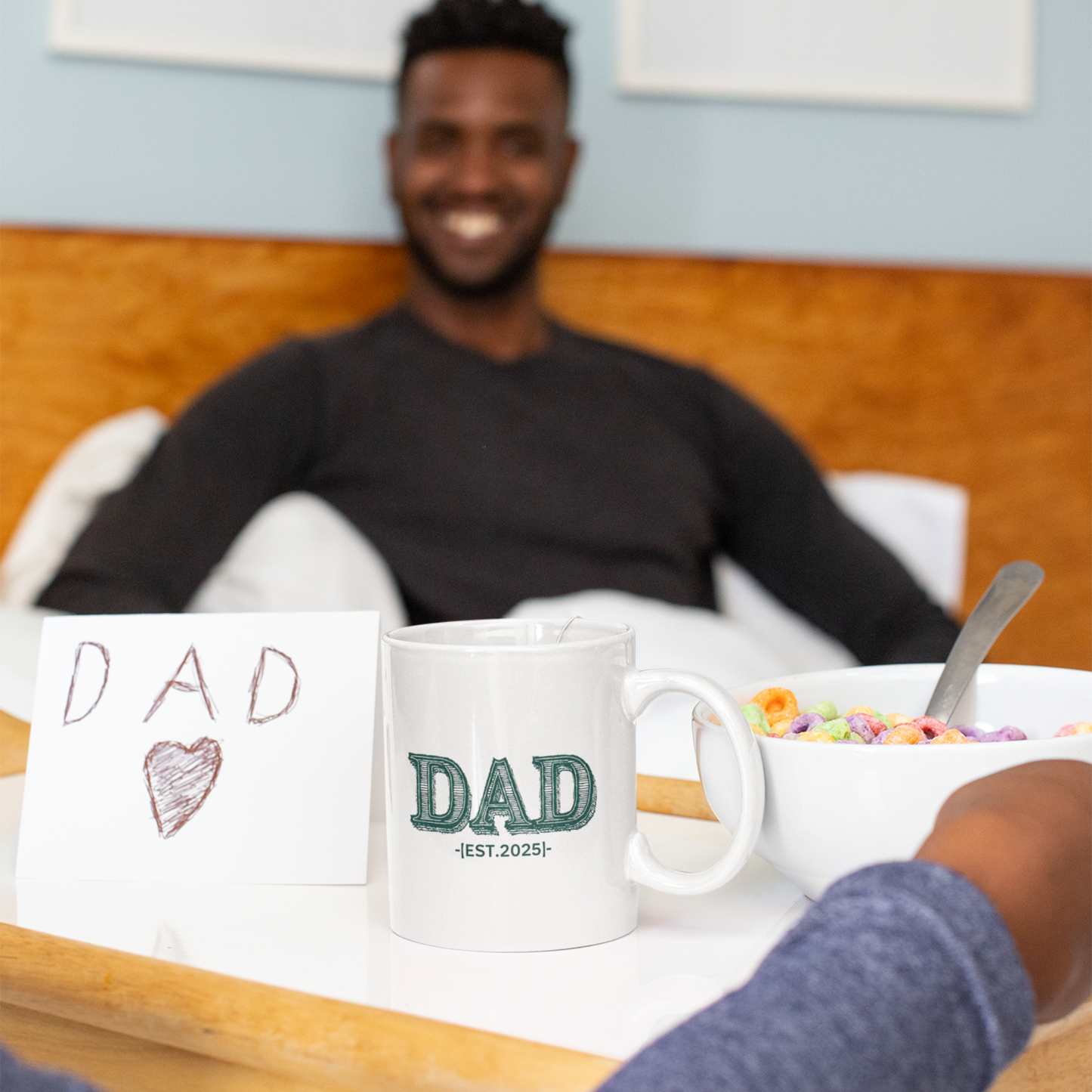 White ceramic coffee mug with bold green vintage-style "DAD" lettering and the text "EST. 2025" below.