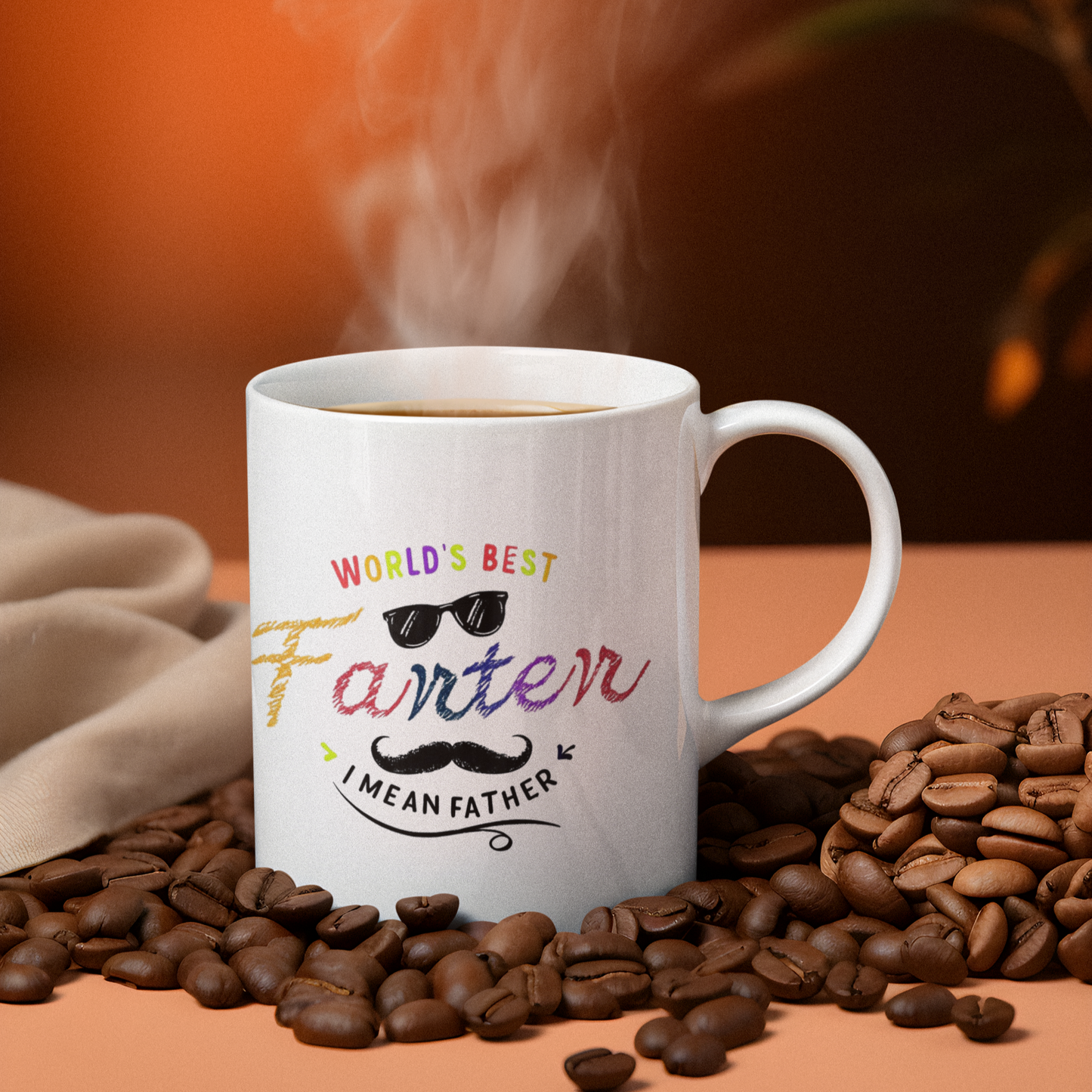 White ceramic mug with colorful text saying “World’s Best Farter I Mean Father,” featuring playful fonts, sunglasses, and a mustache graphic.