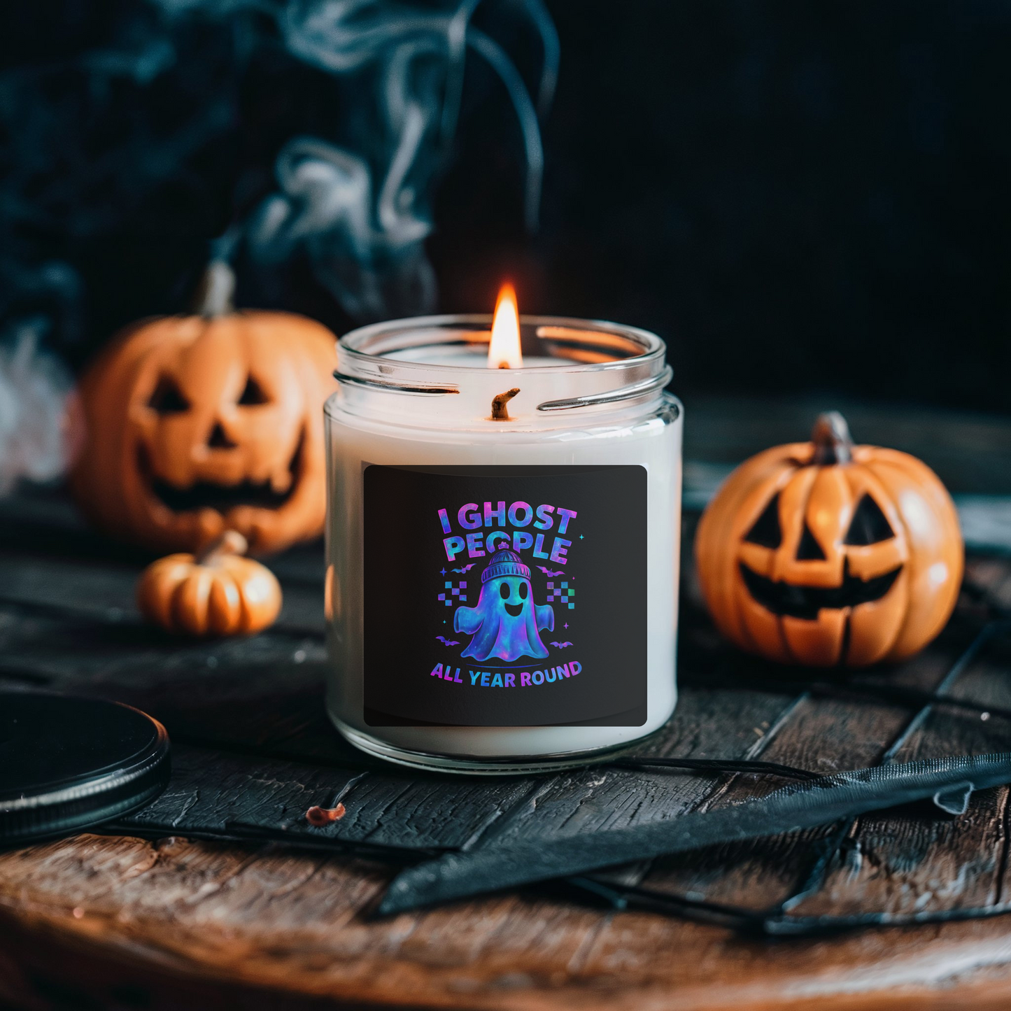 Halloween-themed candle with pumpkins and a dark background