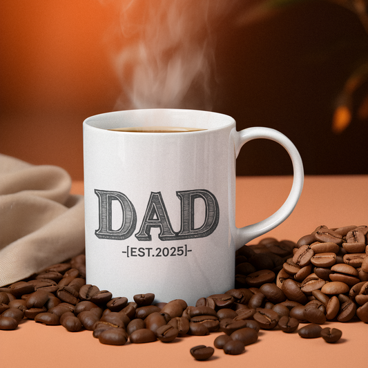 White ceramic coffee mug with bold black text “DAD EST. 2025” printed on the front, designed as a gift for new or expecting fathers.