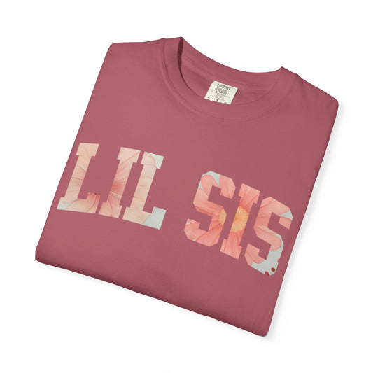 T-shirt with “LIL SIS” text in floral patterned letters, displayed in rose, lilac, black, slate blue, and charcoal colors