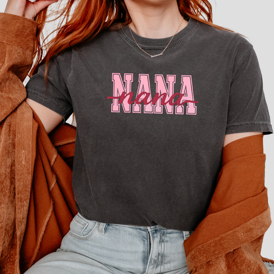 Women wearing vintage-style graphic t-shirts with “NANA” in pink varsity block letters and red cursive script, shown in black, blue, green, and cream colorways in lifestyle settings