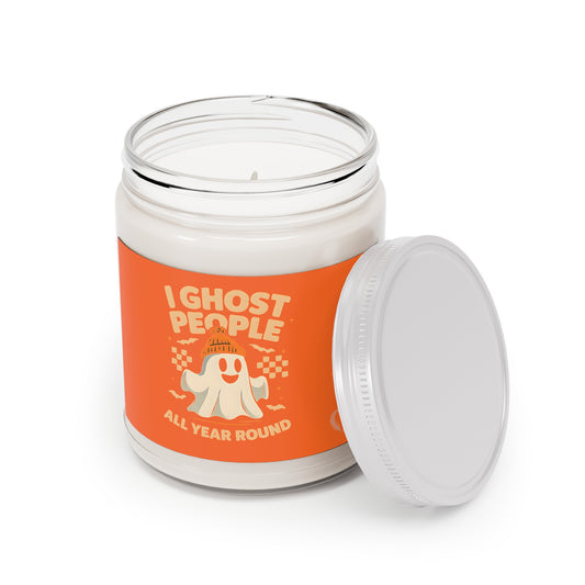 Candle jar with an orange label featuring a ghost graphic and text on a white background