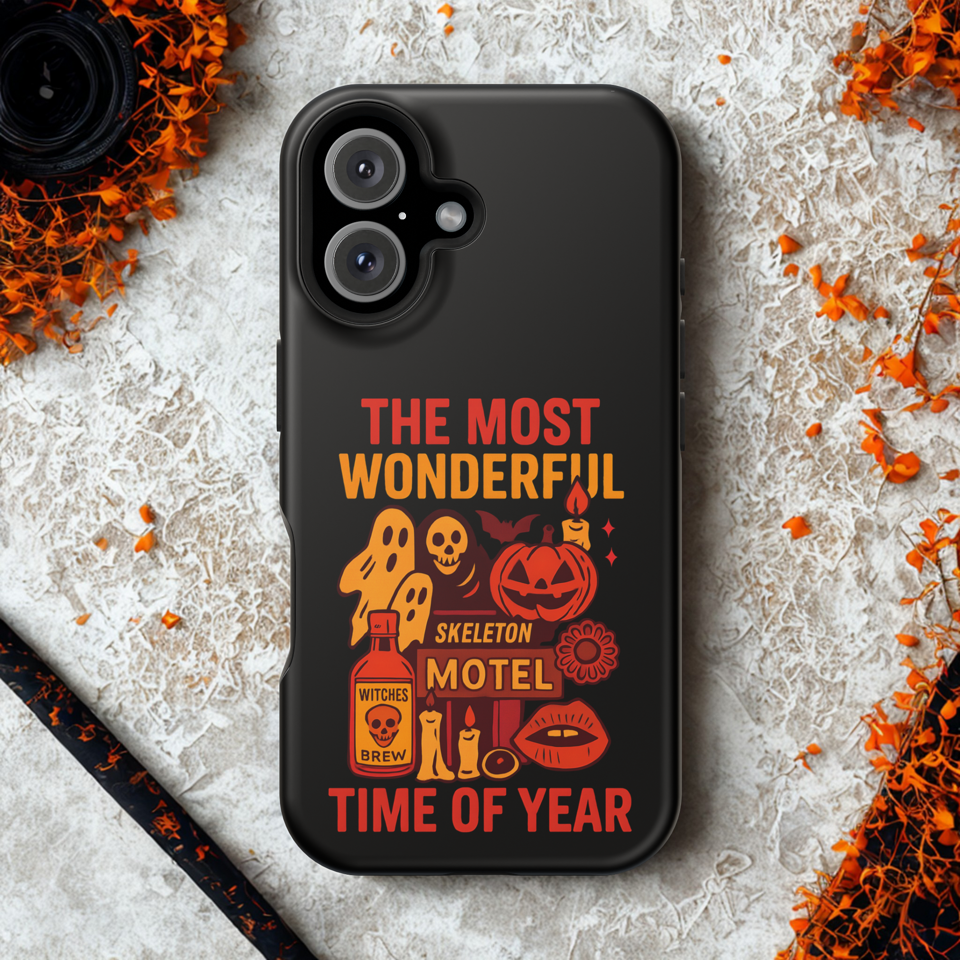 Black phone case with Halloween-themed design on a textured surface with decorative elements.